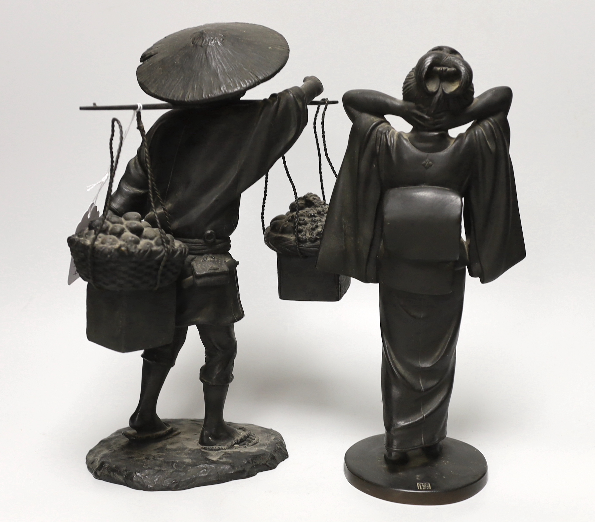 Two Japanese bronze figures of a Geisha wearing a kimono, cast seal mark, and the second a farmer, both Meiji period, the largest 31cm high